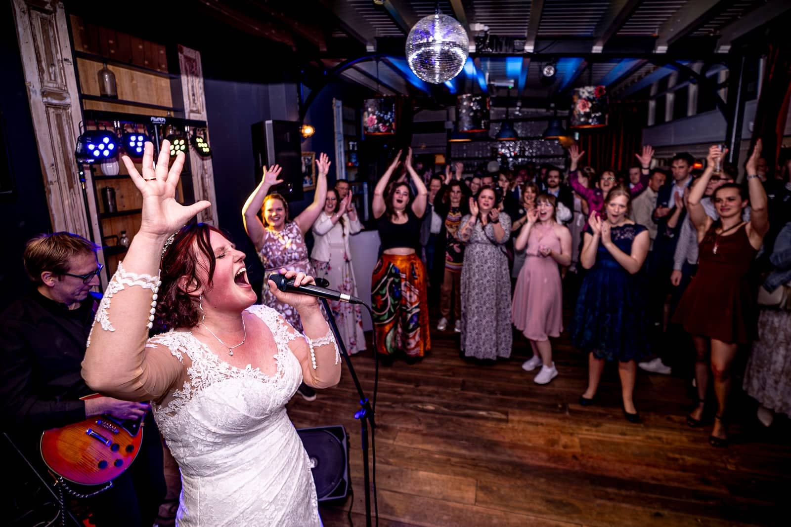 The bride sings her heart out with the band as the guests go wild