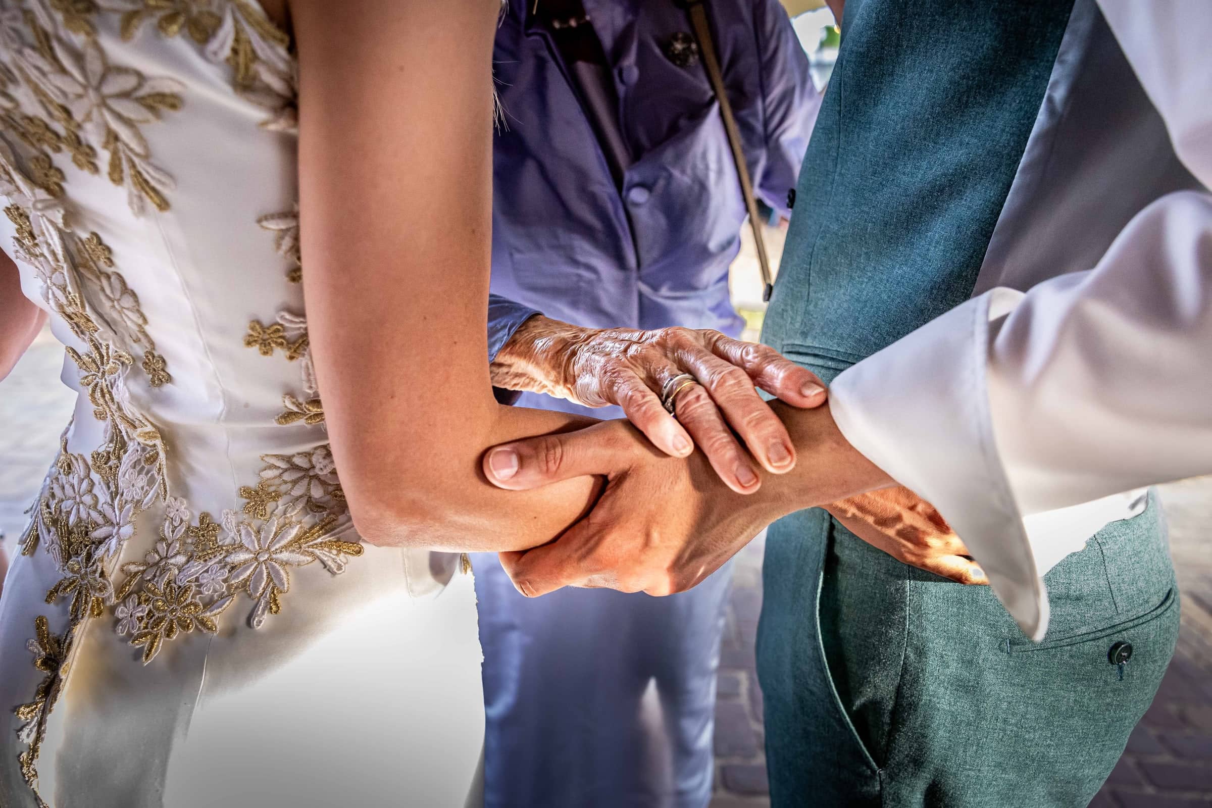 Close-up of hennaed hands holding each other
