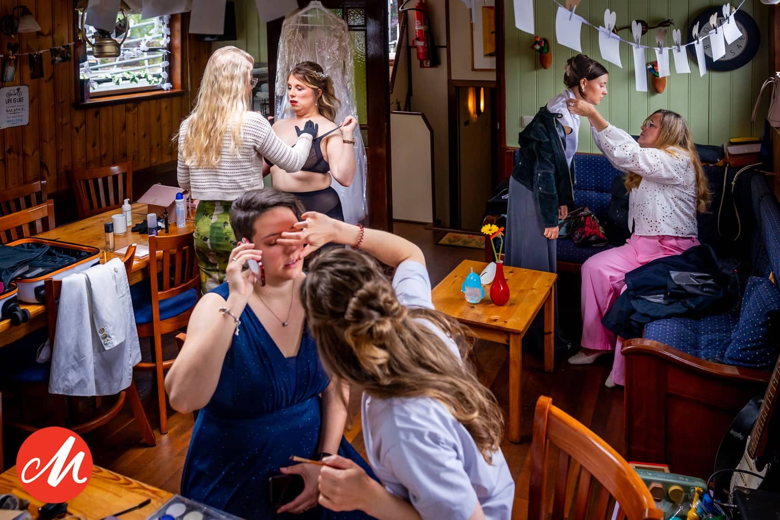 Getting ready in a cosy pub: friends do their make-up and change between the tables