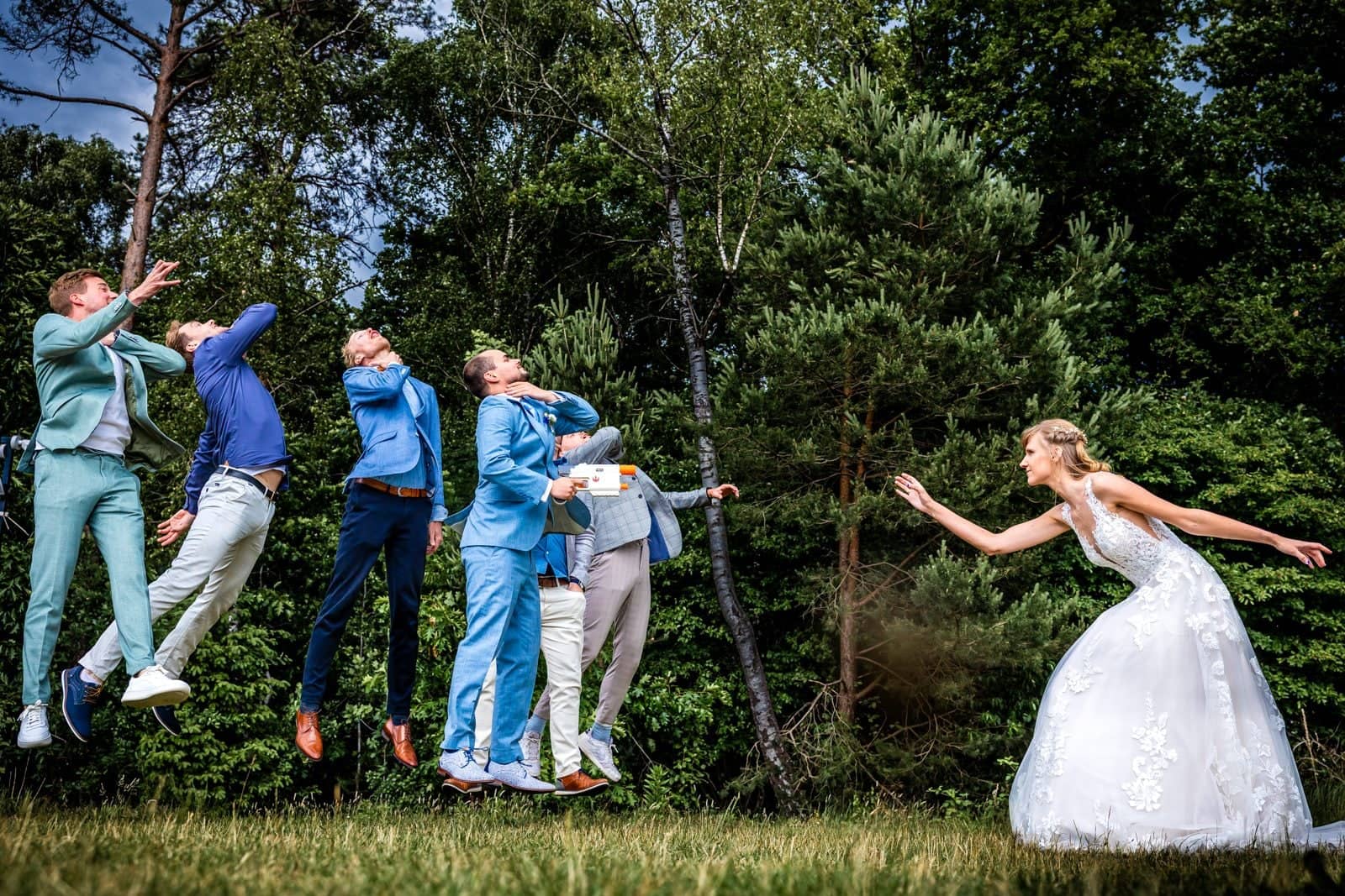 The bride “blows away” the groom’s friends as they all jump into the air